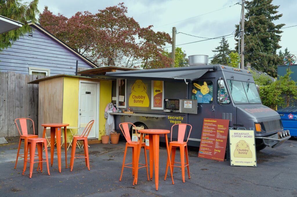 Food cart with orange patio chairs at Alberta Carts