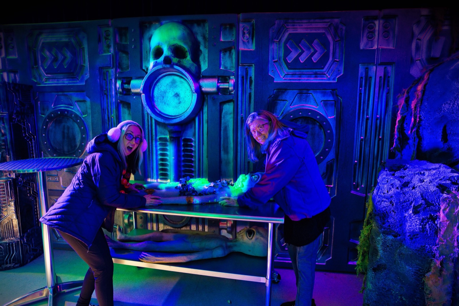 A green alien figure holding a ray gun in the museum alien encounter