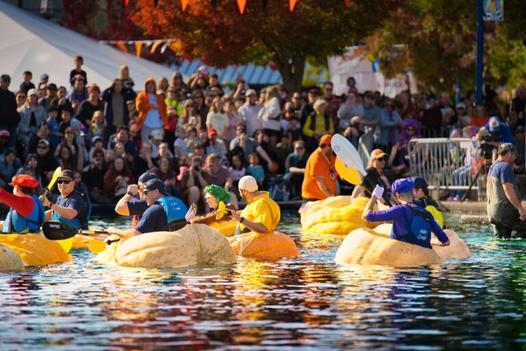 Spectators lined up along the Tualatin Commons lake wall as pumpkin racers wait at the starting line